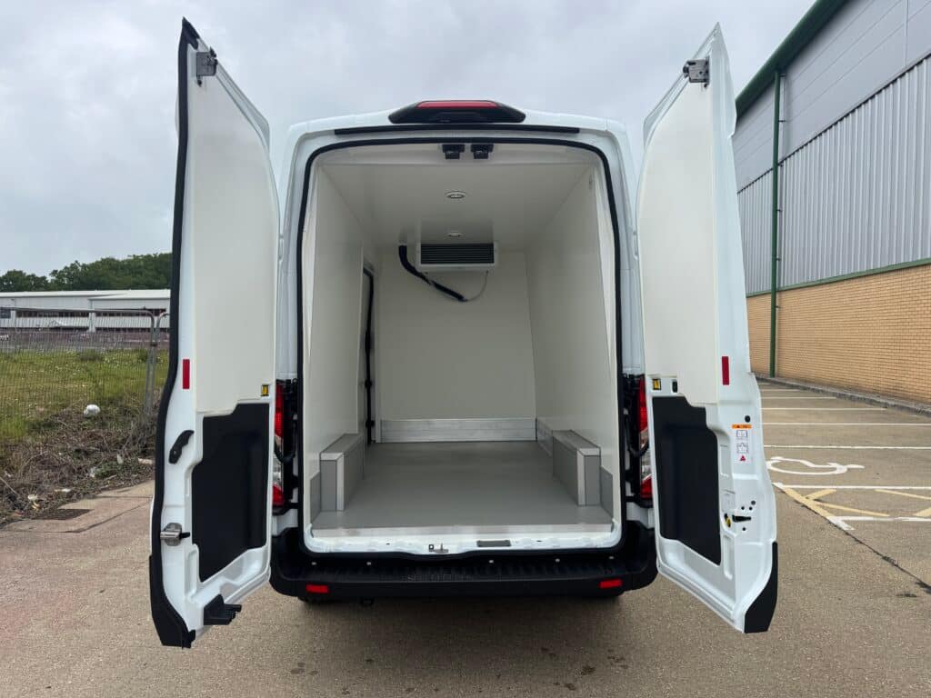 The insulated load space of a Ford Transit fridge van seen through its open rear doors