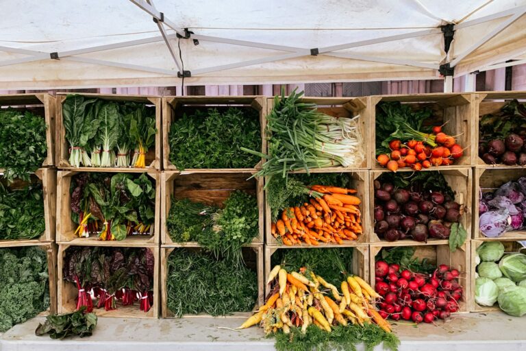Farm shop market stall with fresh vegetables in wooden crates