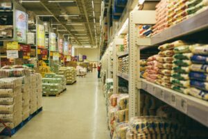 Food wholesale warehouse aisle stacked with sacks and boxes